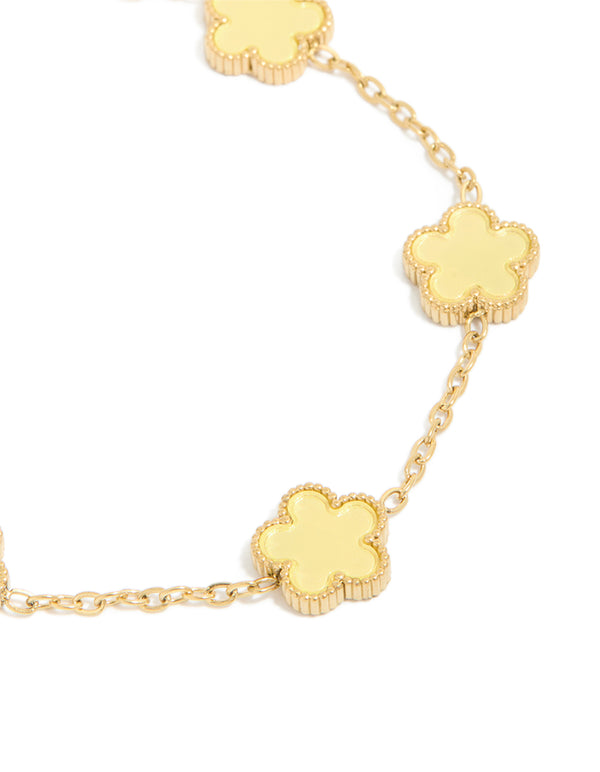Highlighting a waterproof gold plated stainless steel butter yellow flowers charm bracelet in a dainty style close up view