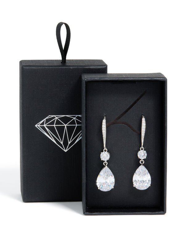 Beautiful silver cubic zirconia pear drop earrings presented in black gift box with diamond logo side view