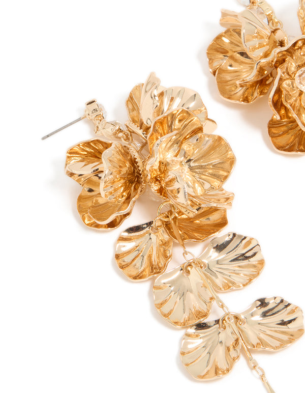 Showcasing gold long floral drop earrings featuring leaf and beads embellishments detail in close up view