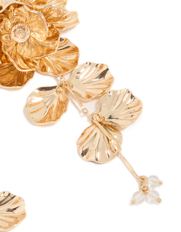 Featuring gold long floral drop earrings with intricate leaf and beads in post detail view