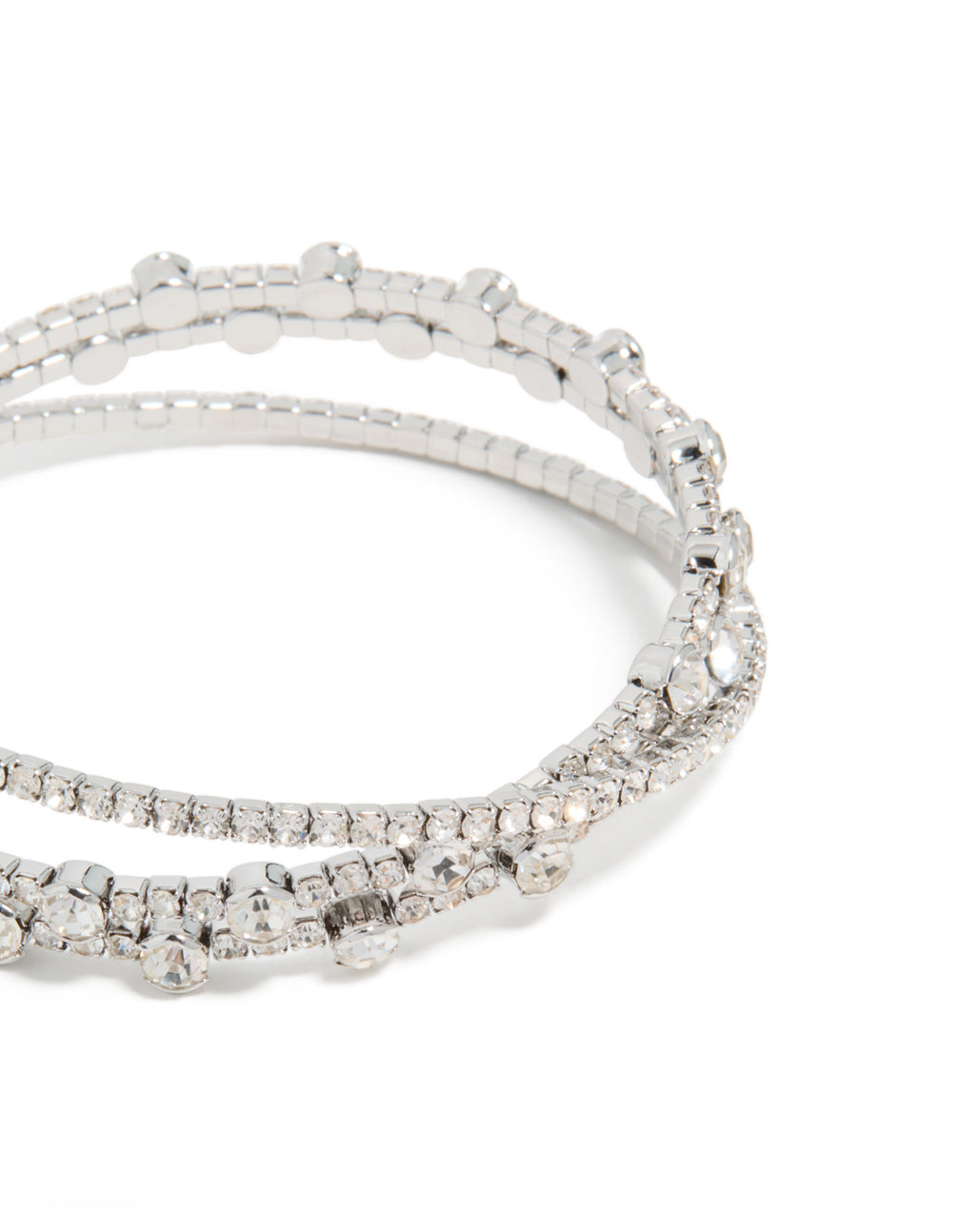Highlighting silver diamante crossed circle wrist cuff,statement bangle in close up view