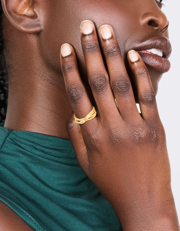 Featuring a waterproof gold plated stainless steel crossed line ring with statement design on finger view