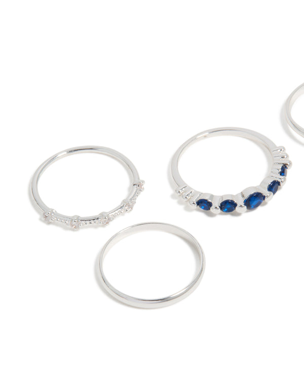 Showcasing silver plated dainty cubic zirconia stacking rings 5-pack with royal blue and clear stones close up view
