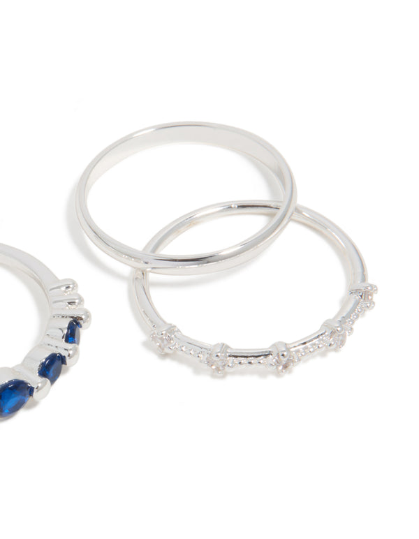 Showcasing silver plated dainty cubic zirconia stacking rings 5-pack with royal blue and clear stones close up view