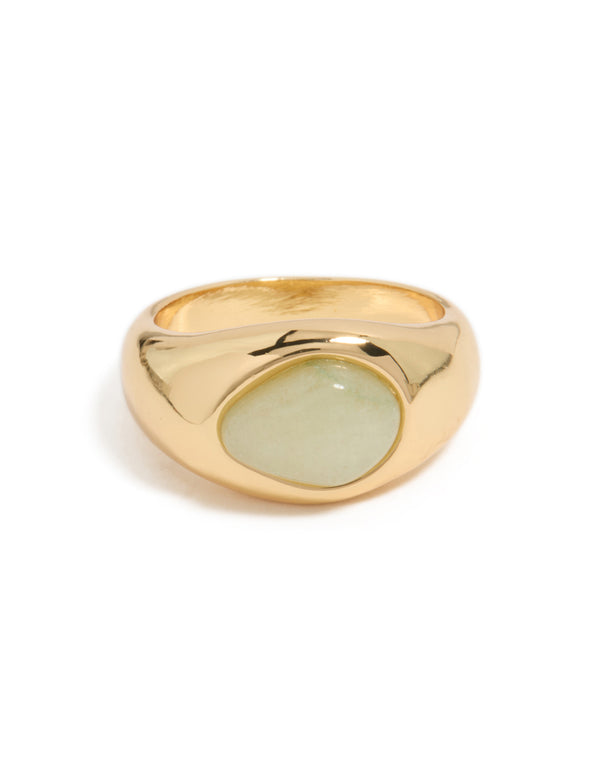A gold plated statement ring with an oval pale green stone side detail view