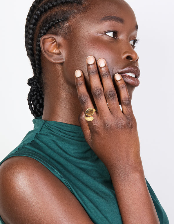 Crafted from waterproof gold plated stainless steel tigers eye round stone wrap ring on finger view
