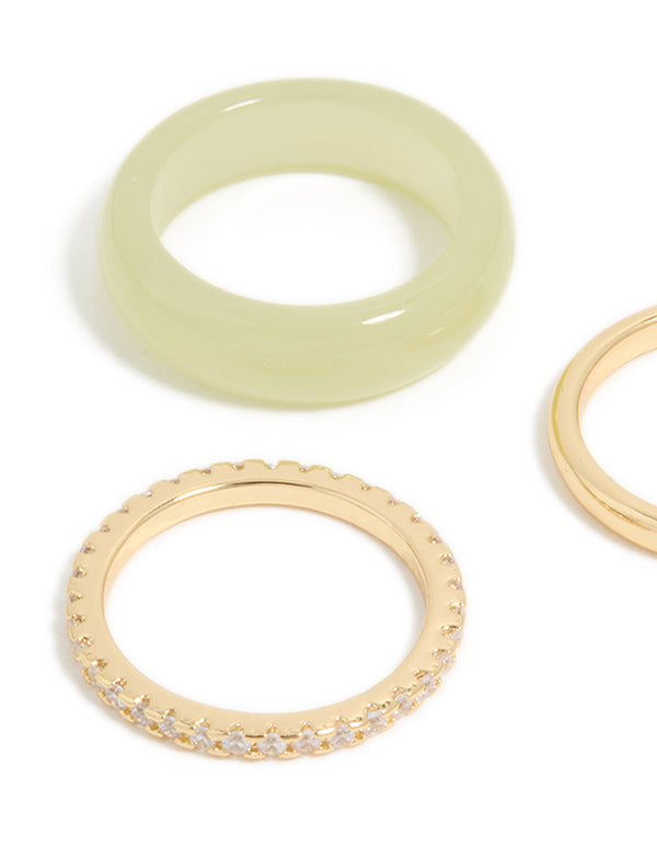 Crafted from cubic zirconia, gold plated, and acrylic materials, these statement rings showcase a 3-pack arrangement in khaki and clear stone accents close up view
