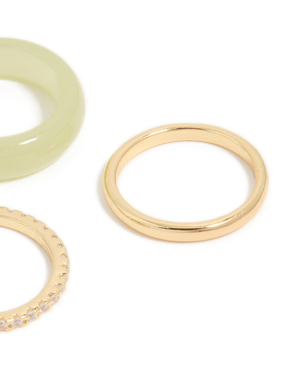 Crafted from cubic zirconia, gold plated, and acrylic materials, these statement rings showcase a 3-pack arrangement in khaki and clear stone accents close up view