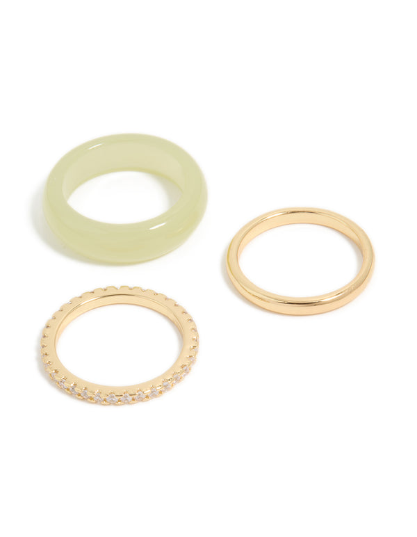 Showcase a set of three statement rings with cubic zirconia, gold plated, and acrylic materials in gold, khaki, and clear stones front view