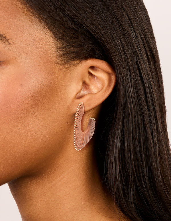 Showcasing gold modern brown wrapped hoop earrings with textured design on ear view