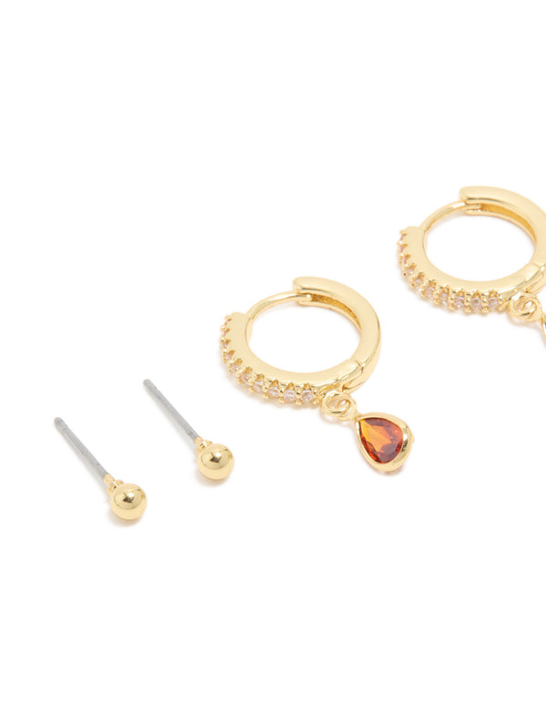Beautifully crafted gold plated brass ruby cubic zirconia July birthstone 4-pack earrings with crystal in dark orange and clear close up view