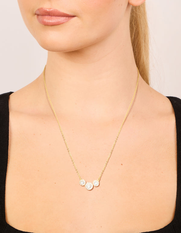 A gold plated cubic zirconia featuring trio halo stone cut necklace on neck view