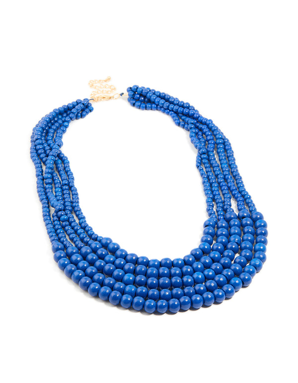 Discover this dark blue acrylic beaded long layered necklace with royal statement gold accents front view