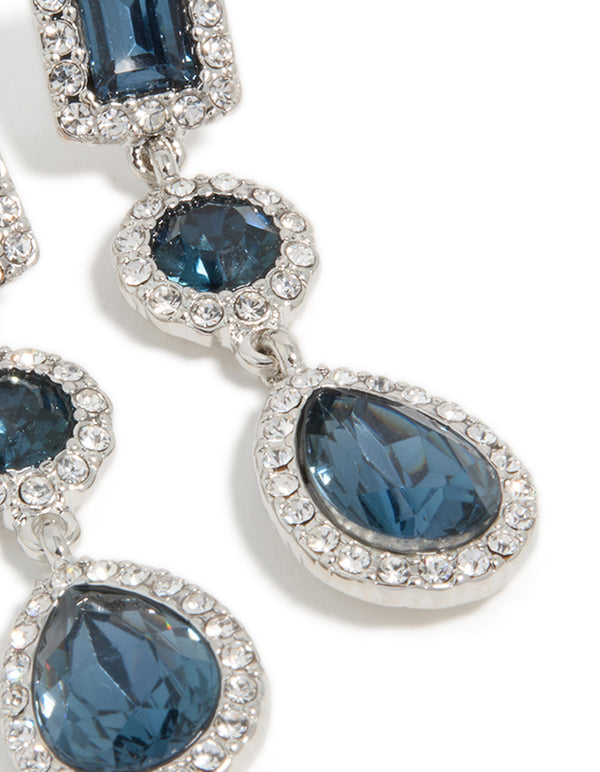 Intricate detailing of teardrop and round blue stones framed by sparkling diamantes in earrings post detail view