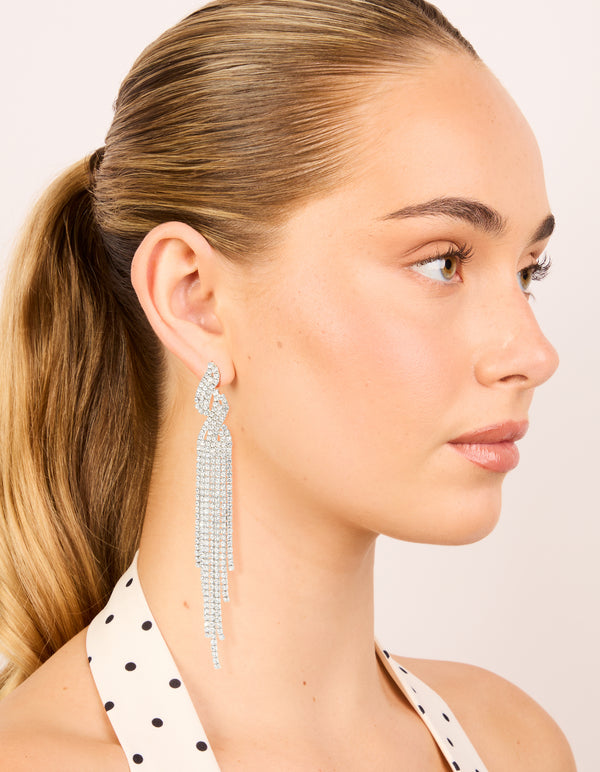 Crafted with silver diamante open curve drop earrings featuring tassel accents on model view