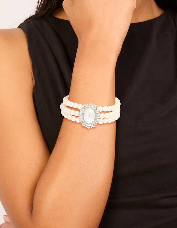Showcasing a silver diamante and pearl layered bracelet on wrist view