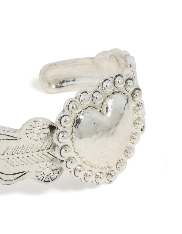 Crafted with silver boho heart wrist cuff featuring floral detailing and statement design in close up view