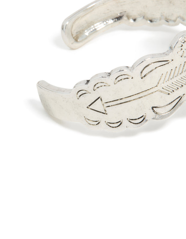 Crafted with silver boho heart wrist cuff featuring floral detailing and statement design in close up view