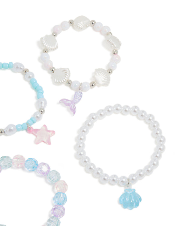 Featuring kids beaded pearl shell stretch bracelets in white light blue lavender and silver with ocean close up view
