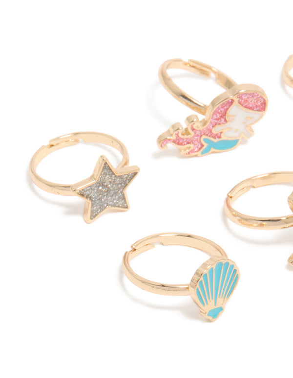 Featuring kids celestial, glitter and ocean shell gold turquoise and pink rings close up view