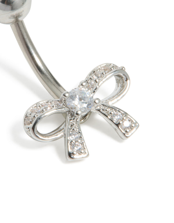Showcasing a surgical steel belly bar featuring bow design with pavé cubic zirconia close up view