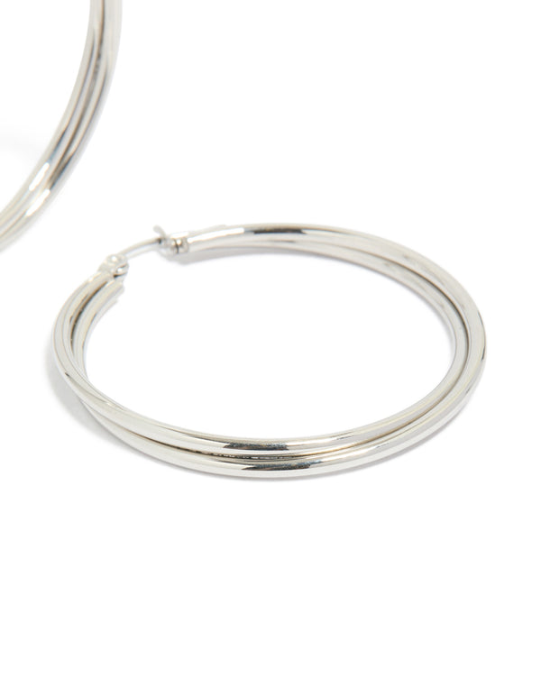 Highlighting surgical steel crossover hoop earrings in silver 40 MM close up view