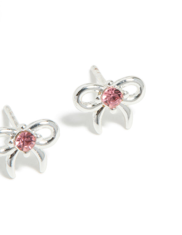 Featuring kids stud earrings made with waterproof stainless steel, bow feature and pink cubic zirconia in a post detail view