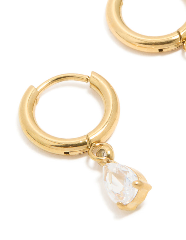 Crafted from waterproof gold plated stainless steel, featuring pear cut cubic zirconia charm huggie earrings close up view