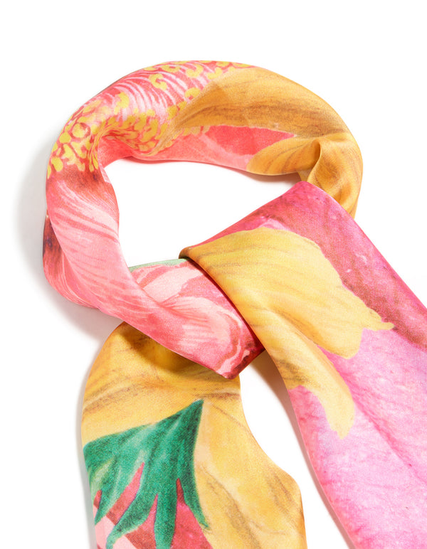 Showcasing a multicoloured statement fabric flower print scarf in coral, gold, light pink, and green side view