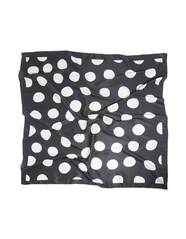 Showcasing a black and white statement polka dot fabric scarf front view