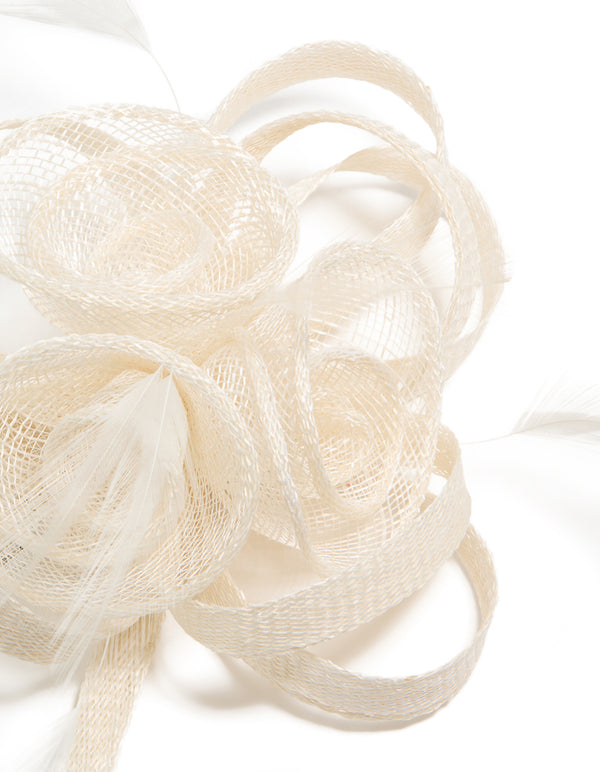 Elegantly crafted white sinamay fabric swirl hair clip featuring floral and feather in ivory detail view