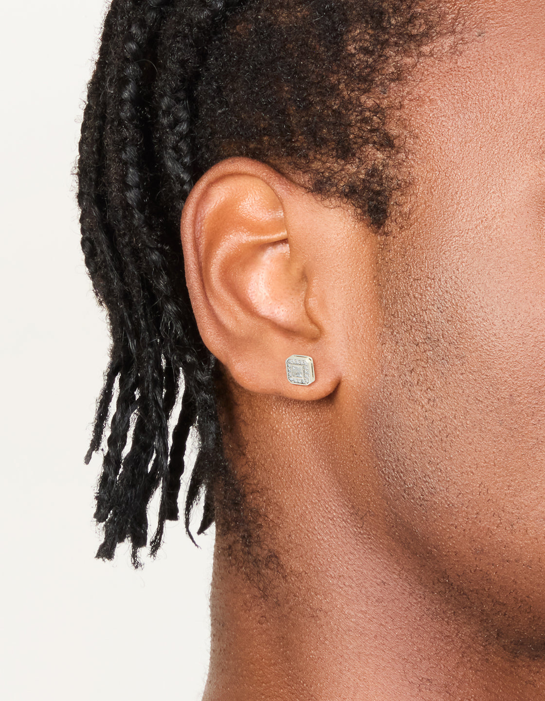 Showcasing mens waterproof stainless steel square cubic zirconia stud earrings in silver on ear view
