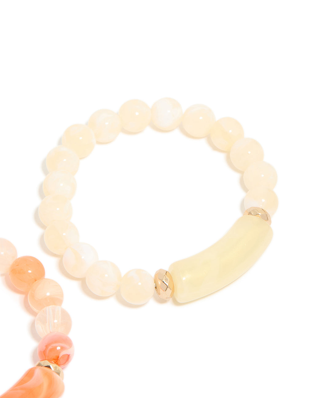 Highlighting pink and cream beaded stretch bracelets in a 2-pack with gold details in close up view