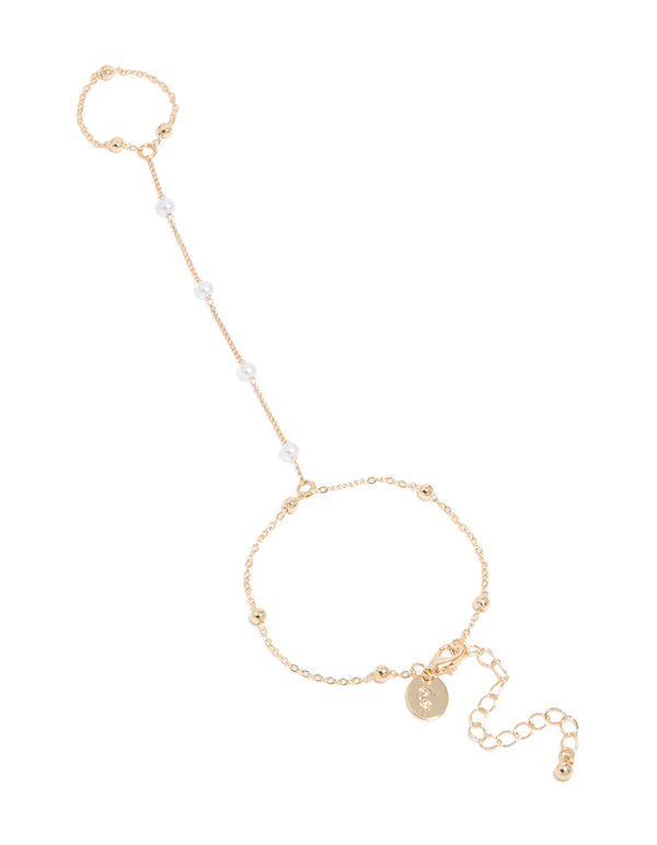 Discover this dainty in gold pearl and ball hand chain featuring in a stylish design front view