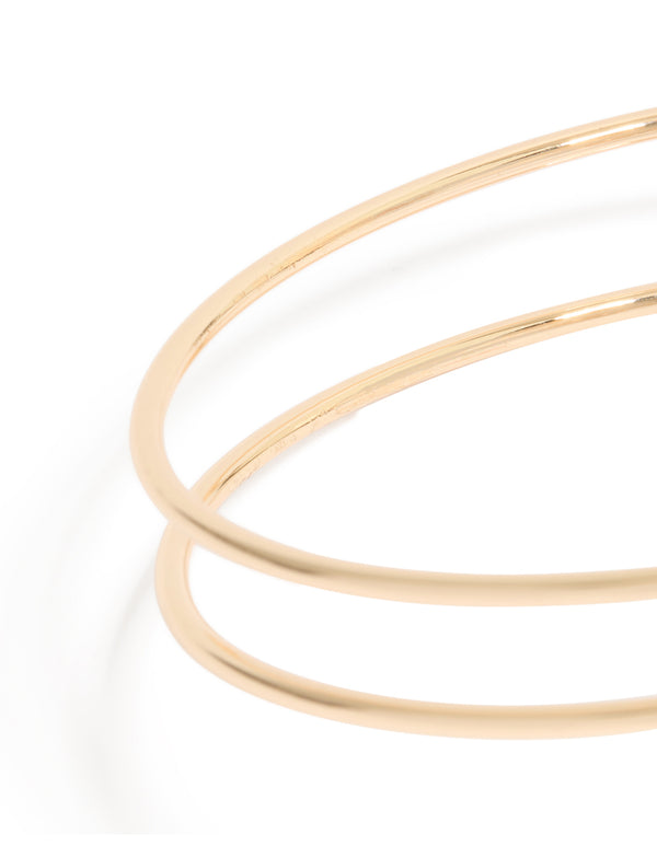 Featuring a gold swirl and brown stones arm cuff with statement design close up view