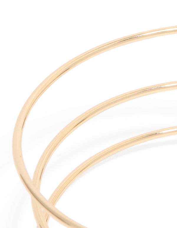Featuring a gold layered butterfly arm cuff in statement style close up view