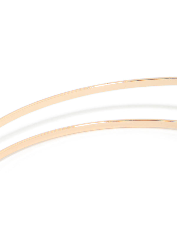 A gold small flower arm cuff with white floral details in close up view