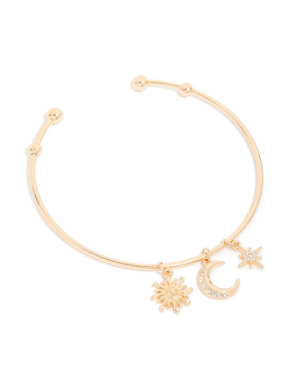 Showcasing a gold celestial charms arm cuff featuring sun, moon, and star statement design in front view