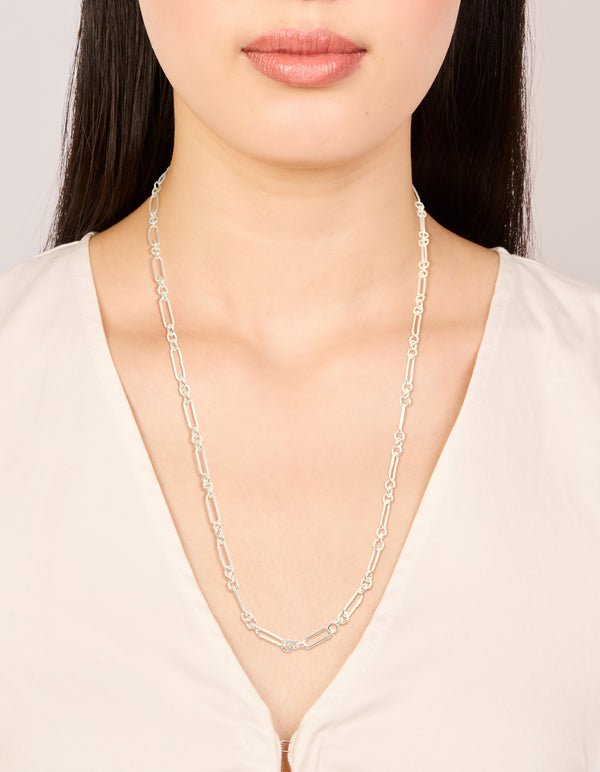 This silver plated long figaro chain necklace showcases elegant styling on neck view
