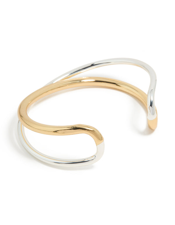 Showcasing a mixed metal open crossover wrist cuff crafted from gold plated and silver materials in a bangle style front view