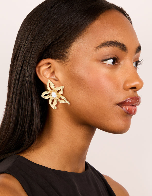 Styled gold plated statement pearl flower earrings model view