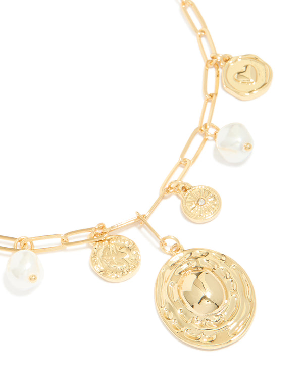 Crafted from gold plated metal, this statement circle charm chain necklace features pearl, sun and coin pendant details close up view