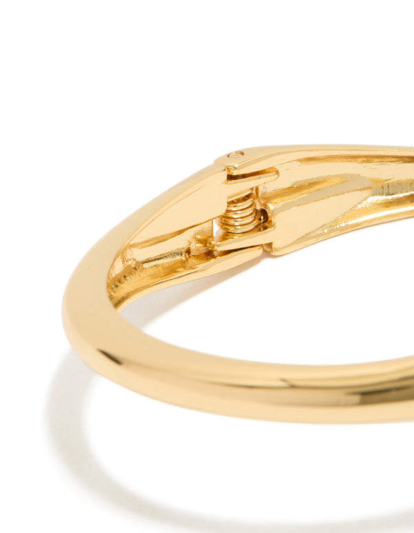 Showcasing the hinged mechanism, this gold plated open wrap bangle features a closure detail view