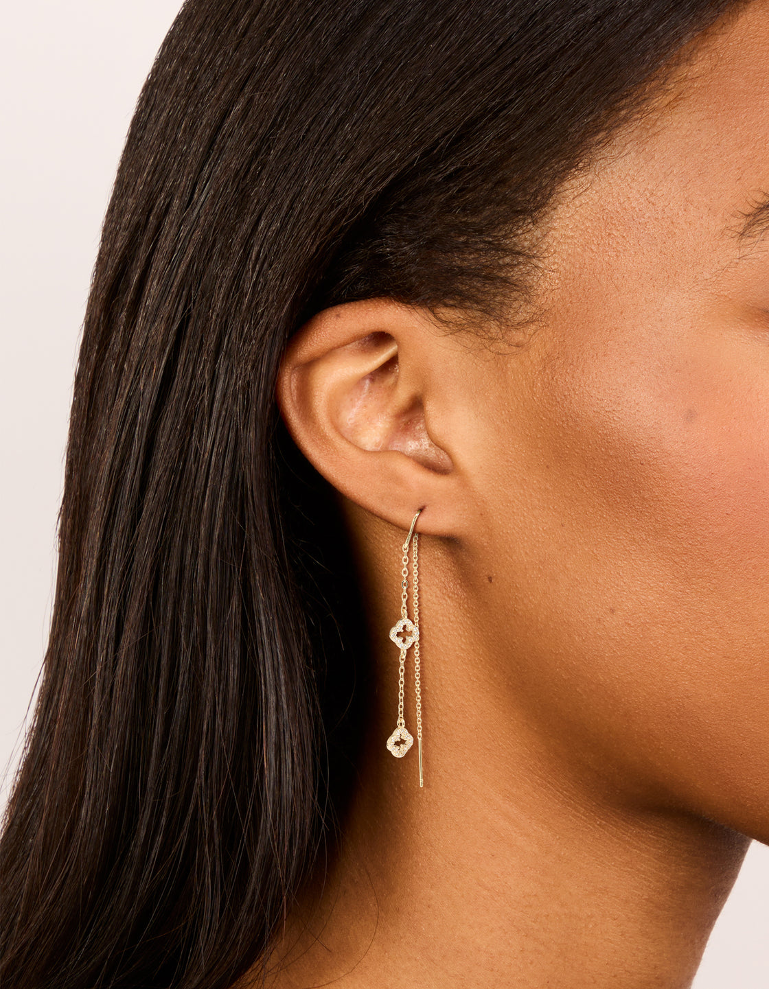 Elegant gold plated cubic zirconia flower thread through earrings on ear view