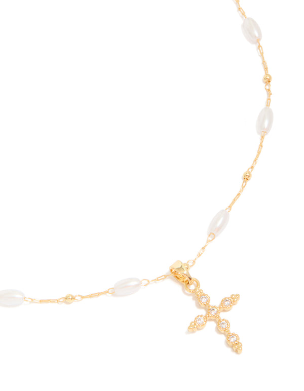 Featuring a gold plated cubic zirconia cross with pearl necklace close up view