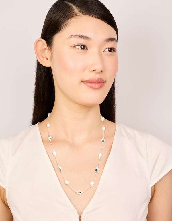 Featuring a silver plated molten and freshwater pearl adjustable necklace on model view
