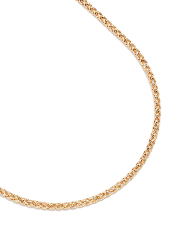 Showcasing a gold cable chain necklace close up view