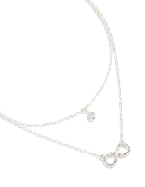 Featuring a diamante with infinity pendant in layered silver necklace close up view