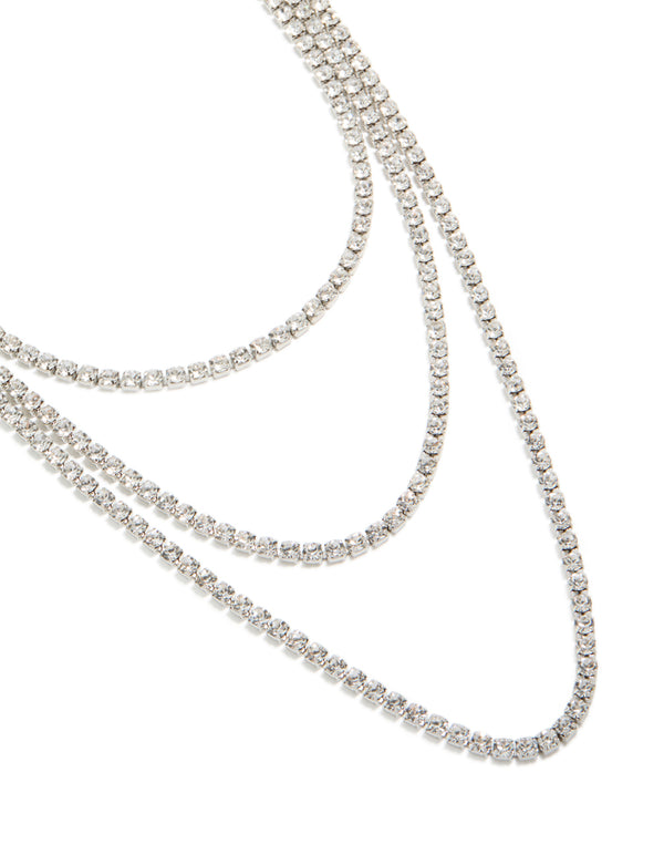 Showcasing a diamante tennis triple layered necklace in silver close up view