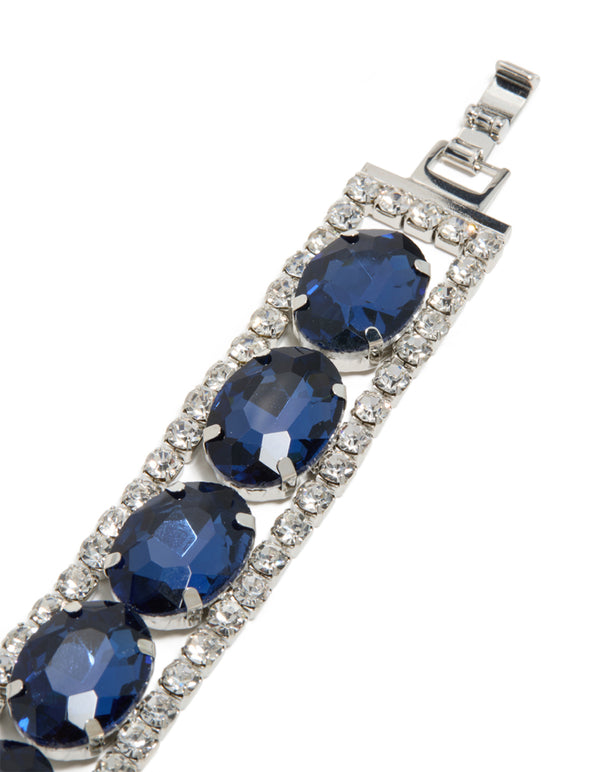 A statement bracelet in silver with blue diamantes, shown in closure detail view